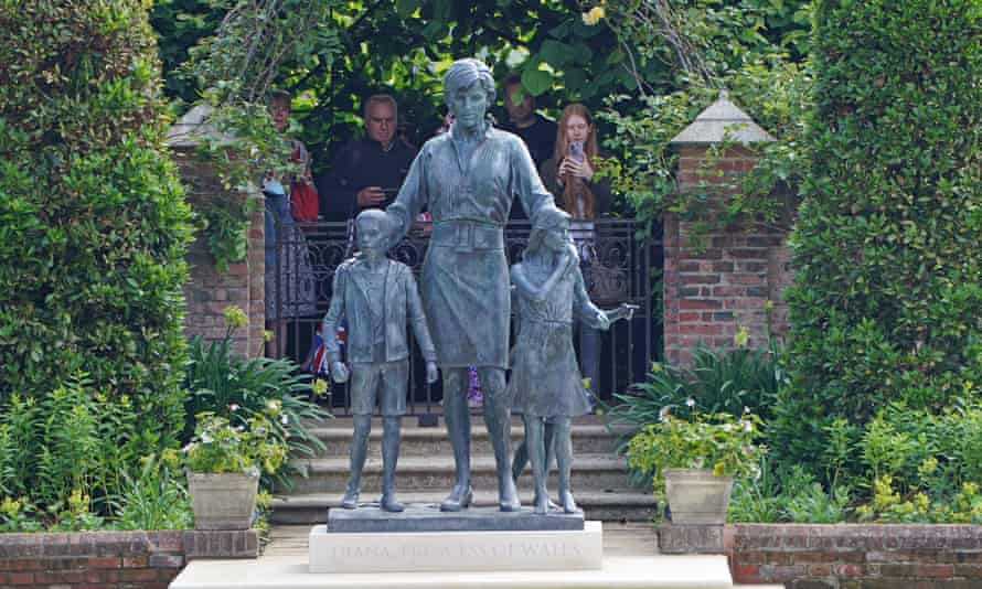 Members of the public view the statue of Diana, Princess of Wales, in the Sunken Garden at Kensington Palace, London on 2 July. 