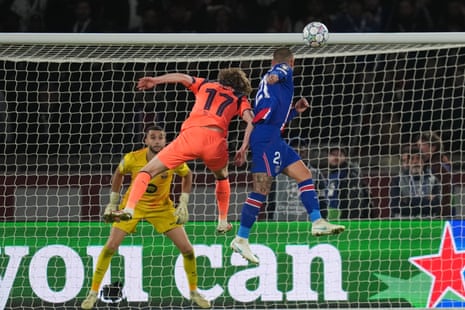 Lucas Hernandez leaps to head the ball past Barcelona's goalkeeper during a Champions League match