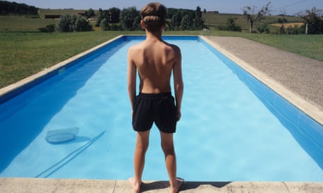 A young boy at a swimming pool.