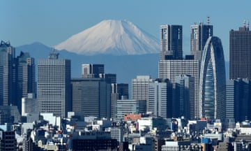 snow-covered mountain in the distance, skyscrapers in the foreground