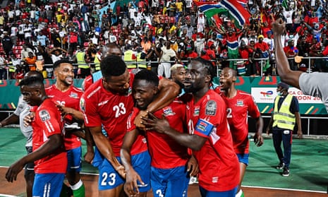 The Gambia's Ablie Jallow celebrates with teammates after scoring against Tunisia