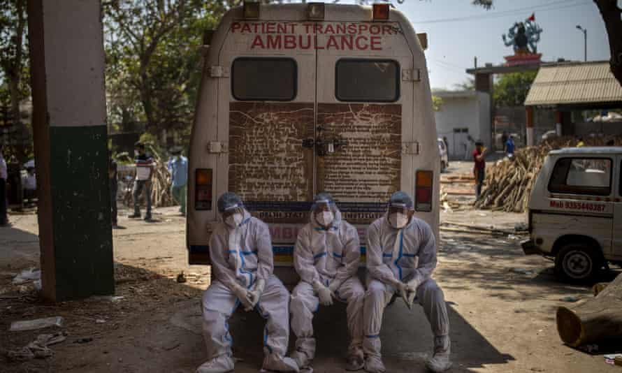 Exhausted crematorium workers in New Delhi, India