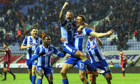 Dan Burn and Wigan celebrate the second goal of their shock win over Bournemouth.