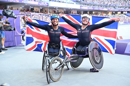 Hannah Cockroft and Kare Adenegan celebrate with British flags in Paris.