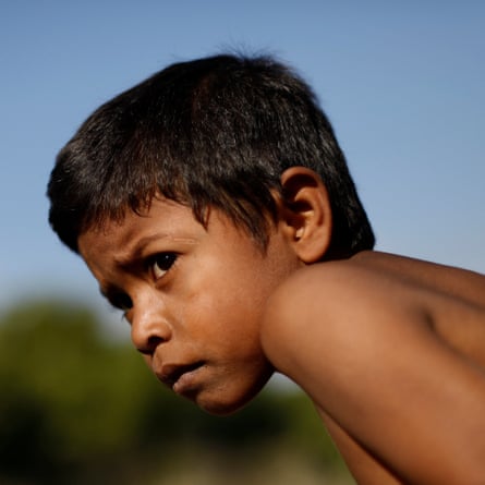 Jose, 7, travels on an open wagon of a freight train, 14 April