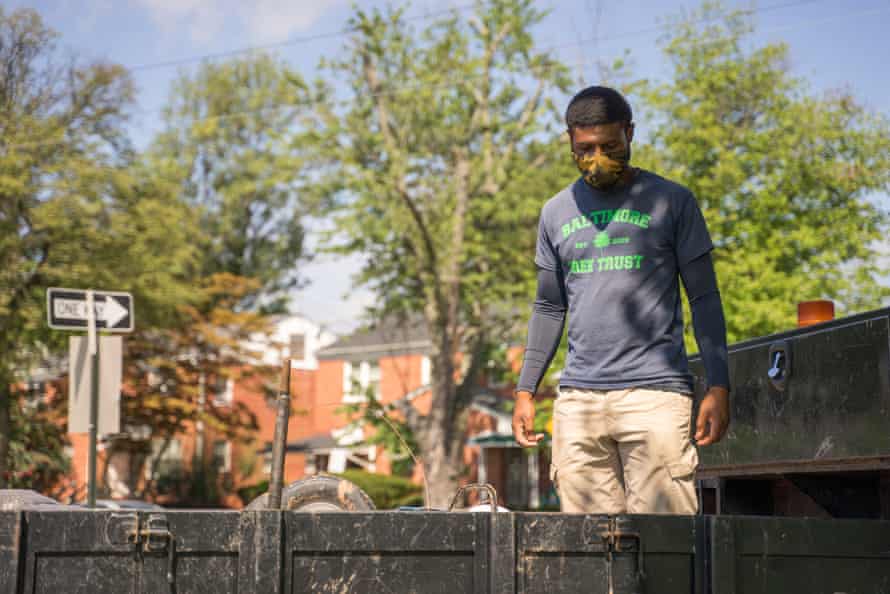 Kwamel Couther, foreman for Baltimore Tree Trust, unloads wheel barrows outside a school in East Baltimore.