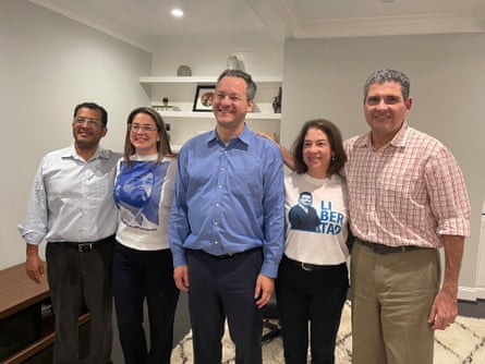 five people posing and smiling