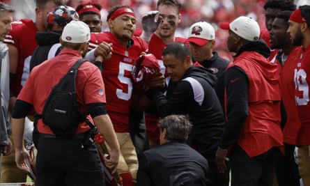 Trey Lance is helped onto a cart after what turned out to be a season-ending injury