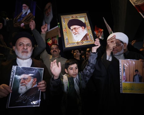 People holding Khamenei's picture at a protest in Iraq