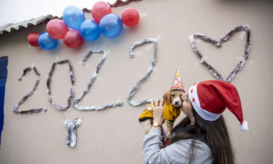 A woman kisses a puppy during the "New Year Party" organised by Sariyer Municipality at Kisirkaya Safiye Kaya Stray Animals Care Center in Istanbul, Turkey on December 29, 2021.