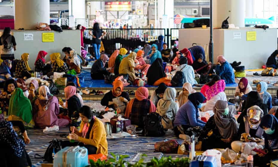 Domestic workers gather on a day off before the new restrictions.