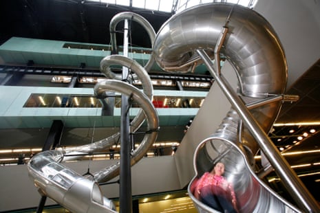 A visitor rides Test Site, Carsten Höller’s slide installation in the Turbine Hall at Tate Modern.