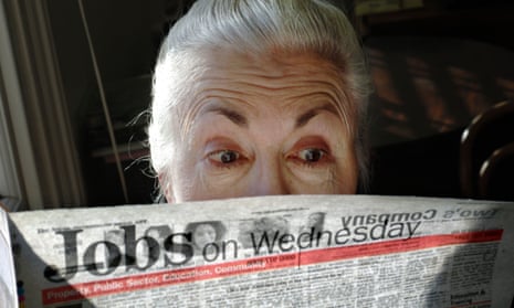 A surprised looking woman pensioner surveys the jobs on offer in her local paper.<br>A0JCYN A surprised looking woman pensioner surveys the jobs on offer in her local paper.