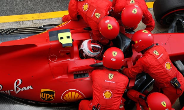 Ferrari mechanics struggle with Charles Leclerc’s car before he is forced to retire from the race.