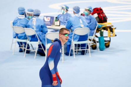ROC athlete Sergei Trofimov comes third in the men’s 5,000m speed skating race, with a medical team on duty in the background.