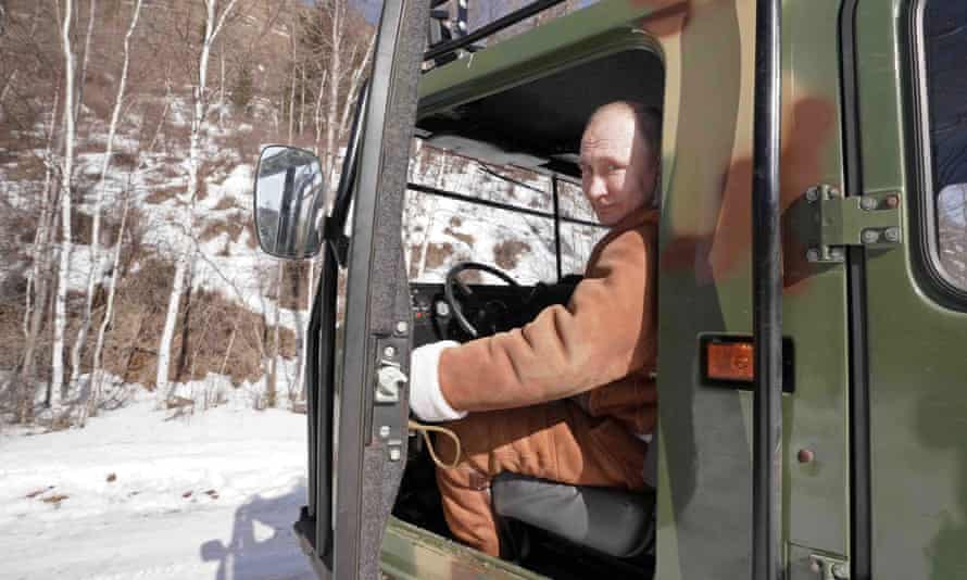 Putin behind the wheel of a cross-country vehicle while driving in Russia’s Siberian federal district in March