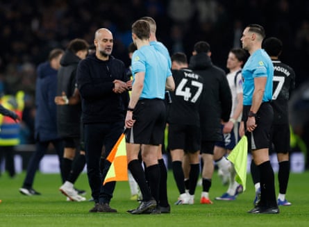 Manchester City’s Pep Guardiola shakes hands with referee Robert Jones.
