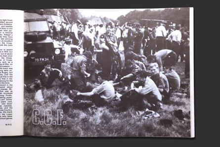 Photograph of magazine page with black and white photo of schoolboys sitting on grass in a field in front of an army Land Rover and cadets in uniform.
