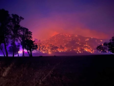 Fire lights the night sky purple