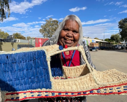 Tjanpi Desert Weaver artist Julie Anderson with a work in progress: a woven police car