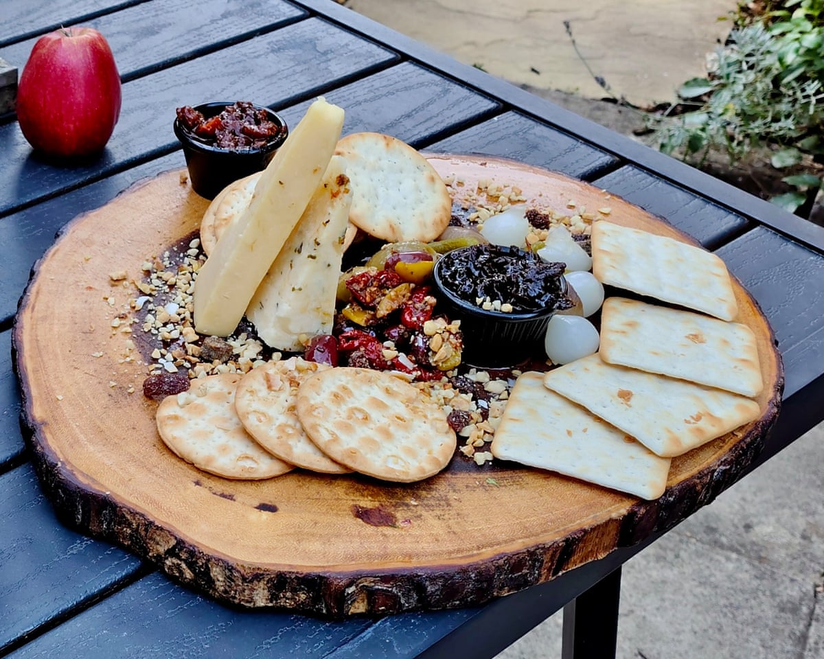 Pictured, the Woolpack Inn’s ‘Woolly cheeseboard ’is served on a slice of tree trunk.