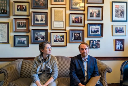 two people sit on a couch