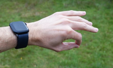 A hand making the pinch gesture while wearing an Apple Watch Series 9.