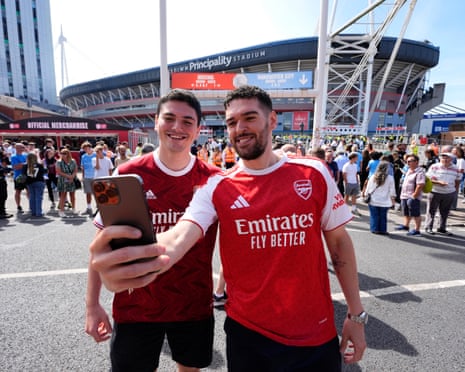 Arsenal fans take selfies outside the stadium ahead of the Community Shield match in Cardiff.