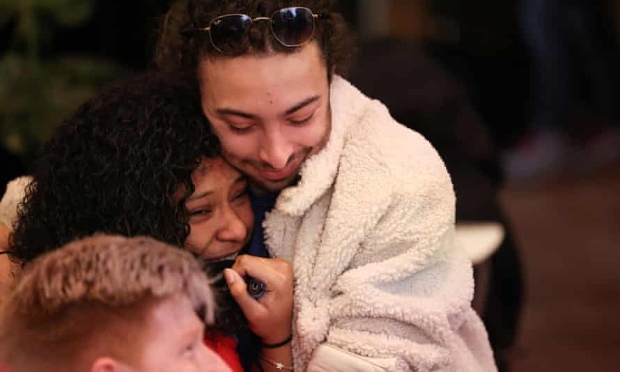 Amazon Labor Union members Mitch Israel and Angelika Maldonado hug after gathering to watch the NLRB vote count to unionize Amazon workers in Brooklyn.