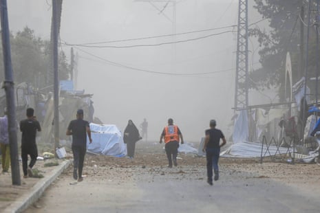Palestinians rush to escape the area after Israeli warplanes' bomb strike on the tents where displaced Palestinians live in Deir al Balah, Gaza on August 21, 2025.