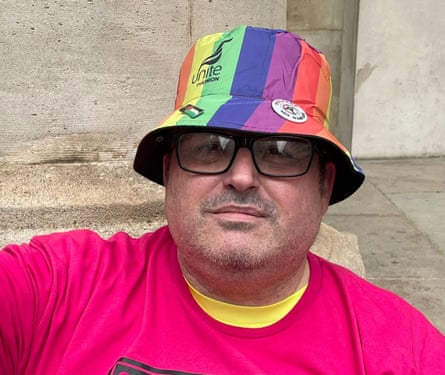 Andy Mitchell in a rainbow sunhat and bright pink shirt