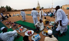 Sudanese men in a suburb of Khartoum prepare to break their fast during Ramadan