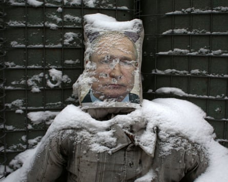 A mounted poster of Vladimir Putin with bullet holes in it