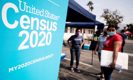 A woman talks with volunteers to fill out the form for the 2020 US Census in Sylmar, California, 17 August 2020. The state lost a congressional seat after the census.