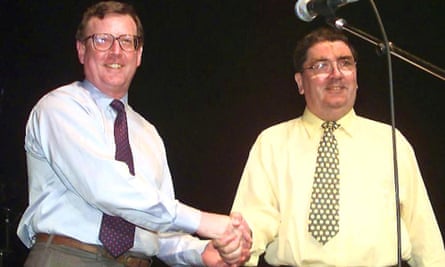 David Trimble (left) shakes hands with Hume on stage at a concert in May 1998 held to celebrate the Good Friday agreement