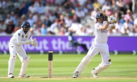 Sri Lanka’s wicketkeeper, Nishan Madushka, watches as Joe Root plays a shot through the covers.