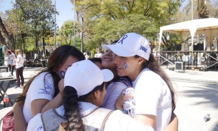 Brisa De Angulo embraces young women who are beneficiaries of her charity in Cochabamba, Bolivia.