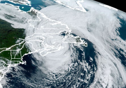 Satellite image showing a huge storm swirling over eastern Canada, with coast and islands outlined 