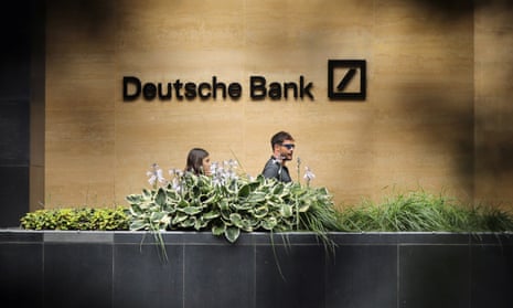 People walk past a Deutsche Bank office in London.