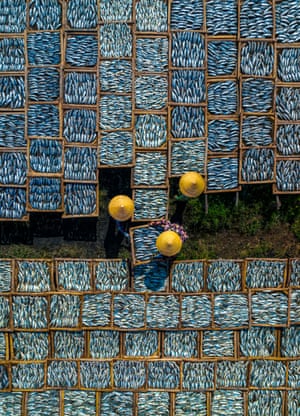 Food Photographer of the Year (South East Asia) | Drying Fish These women are drying fish but they appear to be connecting the coloured patches together. The details of the fish remind me of Van Gogh’s watercolour paintings