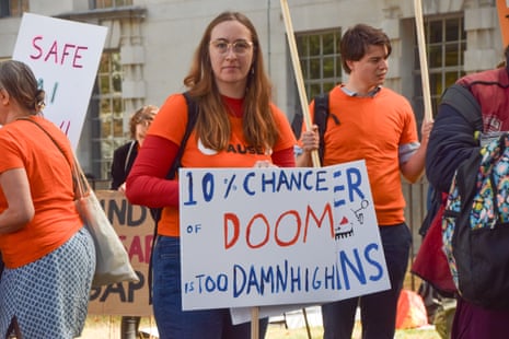A female protester with a placard saying '10% chance of doom is too damn high'