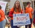 A female protester with a placard saying '10% chance of doom is too damn high'