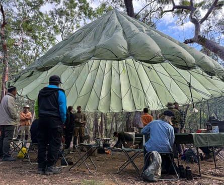 Bush skills class taking place under the military parachute.