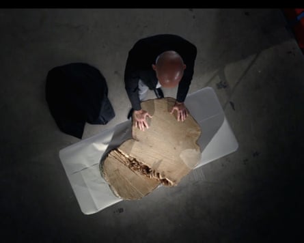 DI Calum Meikle standing at a table with the tree stump on it in The Sycamore Gap Mystery