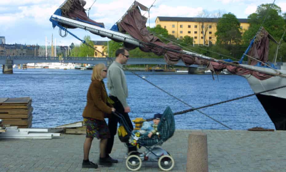 A Swedish couple walking their baby in Stockholm.