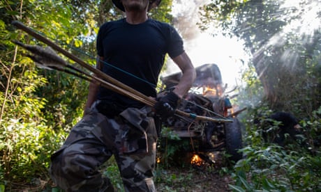A Forest Guardian activist burns a truck belonging to illegal loggers during a recent operation in the Araribóia indigenous territory