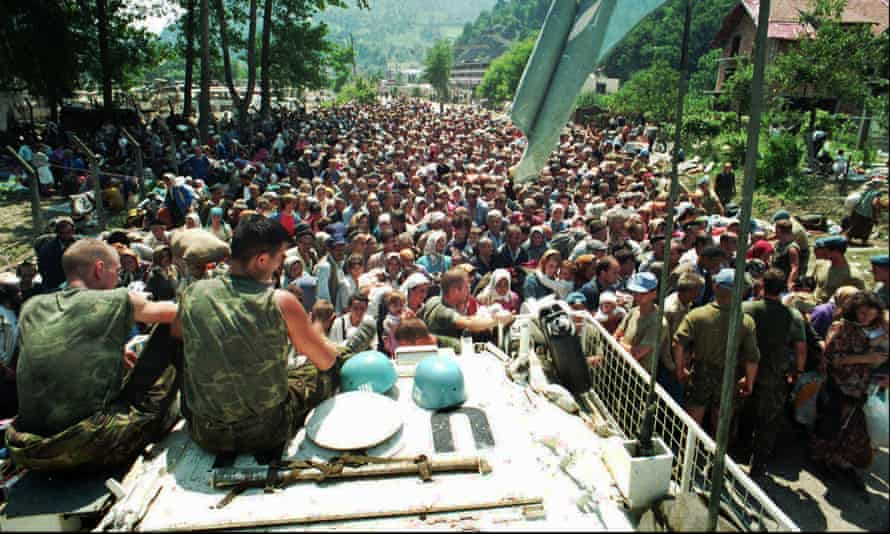 Dutch UN peacekeepers watch Muslim refugees from Srebrenica, eastern Bosnia, gather in the nearby village of Potocari in July 1995.