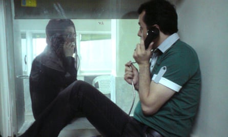 Ahmadian speaking to his wife, Hedayat, through a cabin in Tehran’s Evin prison. 