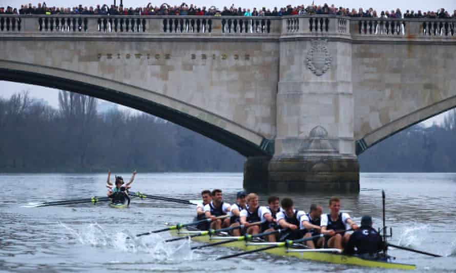 The Cambridge crew, left, celebrate their victory as Oxford trail home.