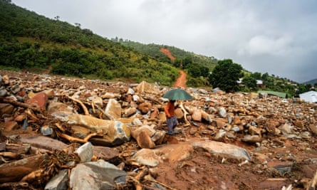 An elderly man walks through the rubble of destroyed buildings in Chimanimani in Zimbabwe.
